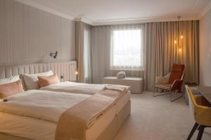 
Ein Bett oder Betten in einem Zimmer der Unterkunft Kongress Hotel Davos
