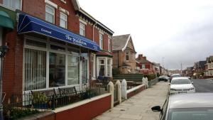 a building with a blue awning on a street at The Middleton in Blackpool