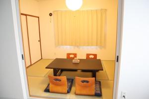 a dining room with a table and chairs at STAY Moiwayama in Sapporo
