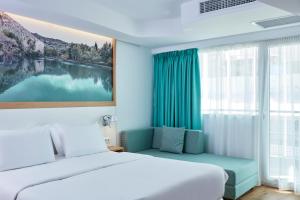 Postel nebo postele na pokoji v ubytování Olive Green Hotel