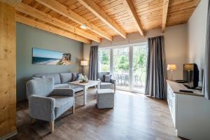 a living room with a couch and a table at StrandResort Markgrafenheide in Warnemünde