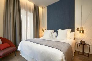 Postel nebo postele na pokoji v ubytování Suites Murillo Plaza Sta. Cruz
