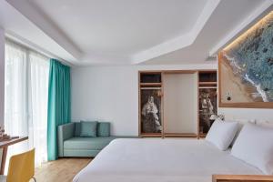 Postel nebo postele na pokoji v ubytování Olive Green Hotel