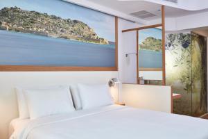 Postel nebo postele na pokoji v ubytování Olive Green Hotel