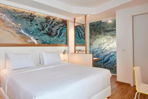 Postel nebo postele na pokoji v ubytování Olive Green Hotel