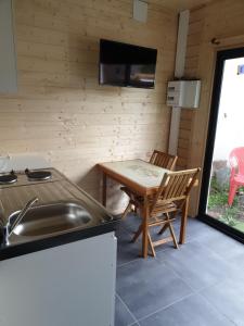 a kitchen with a table and a sink and a table at Romann in Xonrupt-Longemer