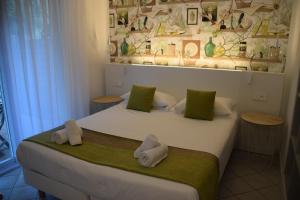 a bedroom with two beds with green and white towels at Prea Gianca in Bonifacio