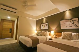 A bed or beds in a room at Escala Tagaytay