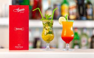 two cocktails sitting on a counter next to a red box at Hotel Nour Congress & Resort in Bizerte