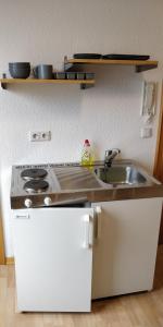 a kitchen with a sink and a stove at TH Exclusive in Düsseldorf