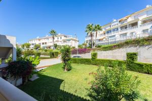 a view from the balcony of a building with a garden at Apartamento Montesol 80 in Torrox Costa