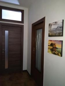a hallway with a door and two pictures on the wall at Federico's House in Ercolano