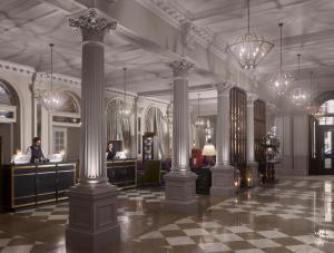 a lobby with columns in a building with people in it at InterContinental Edinburgh The George, an IHG Hotel in Edinburgh