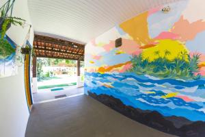 a room with a colorful mural on the wall at Coroaci Beach House in Barra Grande
