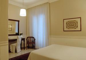 a bedroom with a bed and a desk and a mirror at Hotel Lancelot in Rome