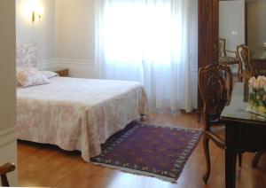 a bedroom with a bed and a table and a window at Hotel Lancelot in Rome