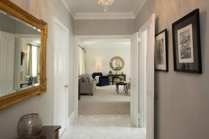 a hallway with a mirror and a living room at The Sherry Netherland in New York