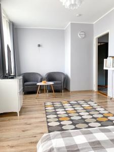 a living room with a couch and a table at Apartament Kotwica in Gdynia