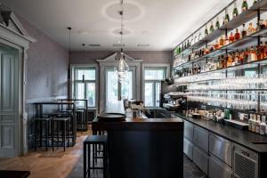 a bar in a restaurant with a counter and bar stools at Villa Rosenaw in Rožnov pod Radhoštěm