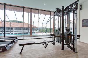 a gym with a large room with a large window at Palmyrah Surin Apartments by Beringela in Surin Beach