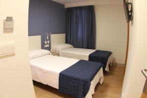 Postel nebo postele na pokoji v ubytování Hostal Mónaco