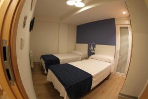 Postel nebo postele na pokoji v ubytování Hostal Mónaco