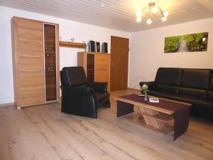 a living room with a couch and a coffee table at Apollonias Gästehaus in Bibertal 