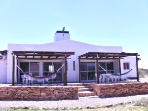 a house with chairs in the front of it at Terrazas al Valle in San Rafael +10 photos