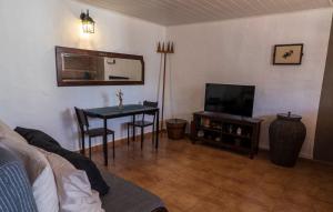 a living room with a table and a television at La Bohemia Apartments in Teror