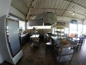 a kitchen with a table and chairs and a refrigerator at Sky Club Eco Hotel in Belén de Umbría