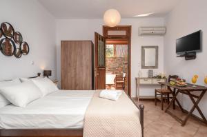 A bed or beds in a room at Theonis Villas