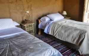 سرير أو أسرّة في غرفة في Eco Nubia