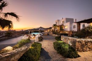 a house with a stone pathway in front of a sunset at Villa Elan Fanari in Fanari