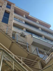 a building with stairs on the side of it at Apartments Stević - Monaco in Budva