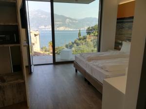 a bedroom with a large window with a view of the ocean at Locanda San Marco in Torri del Benaco +139 photos