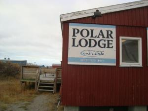 a barn with a sign on the side of it at Polar Lodge in Kangerlussuaq