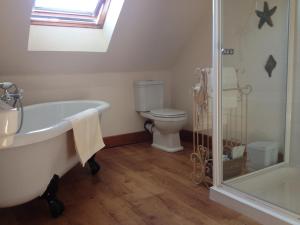 a bathroom with a bath tub and a toilet at Bed and Breakfast at 4 in Thurso