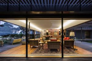 a living room with a view of a house at Lansdowne Farm Lodge in Hawkeswood