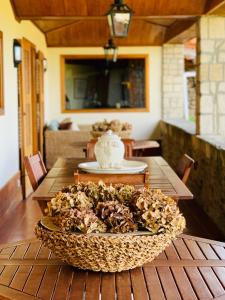 a bowl of food sitting on a wooden table at Casa de Sao Miguel Douro in Armamar