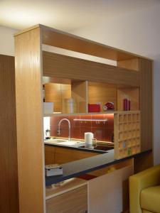 a kitchen with wooden cabinets and a sink at INCANTO A CHIAIA in Naples