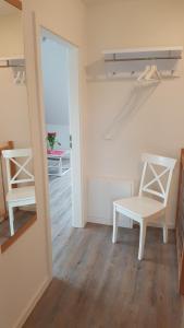 a room with a table and a chair and a mirror at Wohlfühlquartier Louisenlust in Eutin