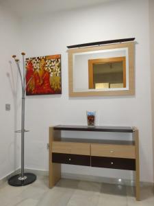 a dresser with a mirror on a white wall at MALDONADO LUJO SUPERIOr CENTRO MALAGA in Málaga +19 photos