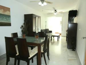 a dining room and living room with a table and chairs at MALDONADO LUJO SUPERIOr CENTRO MALAGA in Málaga