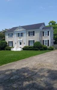 a large white house with a large driveway at 2 BEDROOM SLEEPs 6 SPACIOUS LUXURY APARTMENT 79 in Montgomery