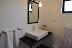 a bathroom with a white sink and a mirror at Casa Verdazul in Tavira +60 photos