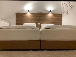 two beds sitting next to each other in a bedroom at Apart 31 in Cetinje