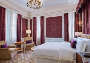 um quarto de hotel com uma cama grande e um lustre em 5th & 55th Residence Club em Nova York