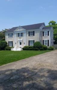 a large white house with a driveway in front of it at 3 BEDROOM SLEEPs 8 NICE SPACIOUS APARTMENT B 89 in Montgomery