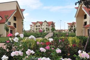 a row of houses with flowers in a yard at Farah Inn Ifrane in Ifrane