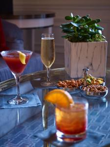 dos copas de bebidas en una mesa con aperitivos en 5th & 55th Residence Club, en Nueva York